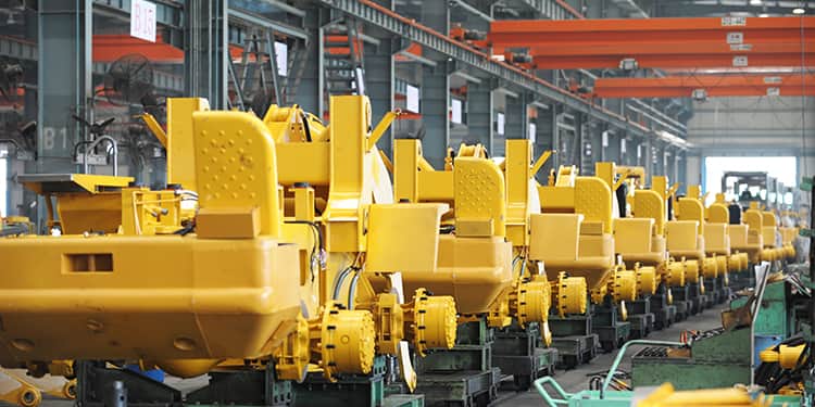 A row of yellow machines lined up in a factory setting.